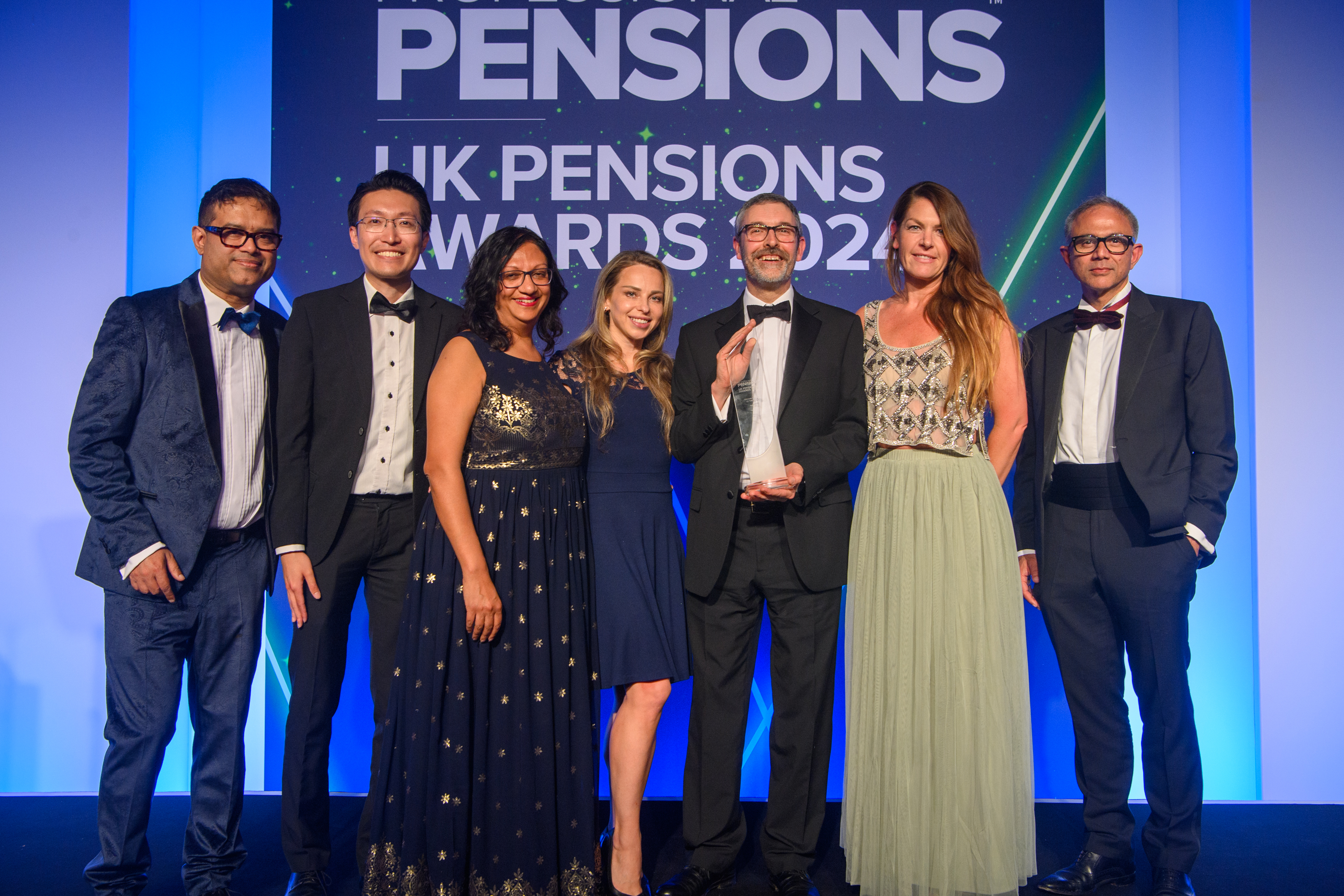 Image shows (from left to right) UK Pension Awards 2024 host, Paul Sinha, Railpen's Jonathan Ho, Harsha Patel, Alena Antonava, railways pension schemes' Trustee, Richard Jones, Railpen's Becks Goodman and award sponsor.